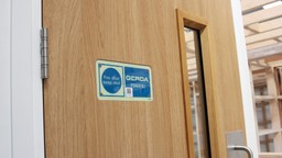 A close-up of a fire door compliance label on a Gerda Security fire door set.