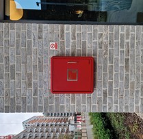 A Gerda Security PIB fixed securely on an external wall of a residential block