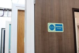 Fire door with 'Do Not Prop Open' sign, safety instructions for residents.