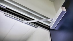 A fire-rated communal door with a soft-close function, reducing noise in residential spaces.